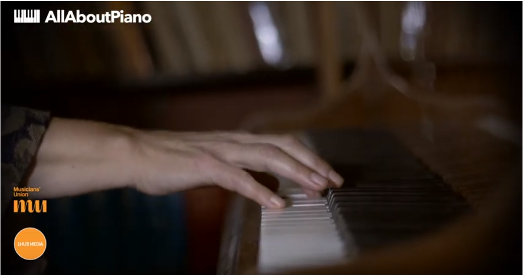 fingers on piano keyboard