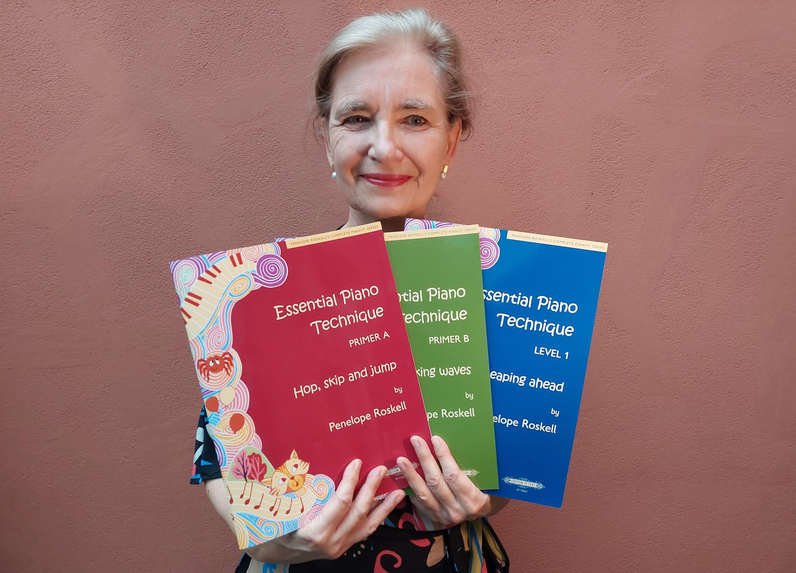 piano teacher holding books, teaching piano to children, piano books for kids, piano books for children and young learners